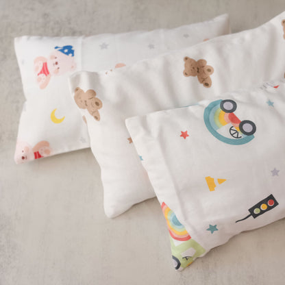Two beansprout husk pillows with cartoon designs on a neutral background