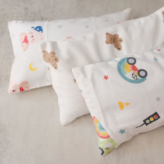 Two beansprout husk pillows with cartoon designs on a neutral background