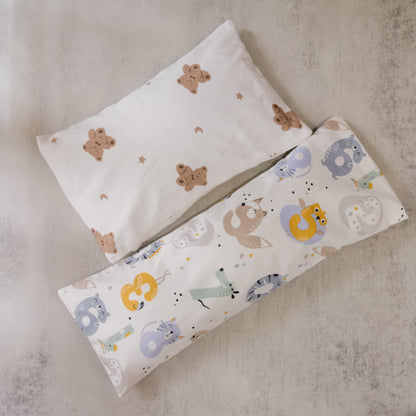 Two beansprout husk pillows with animal patterns on a textured surface