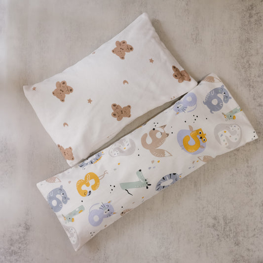 Two beansprout husk pillows with animal patterns on a textured surface