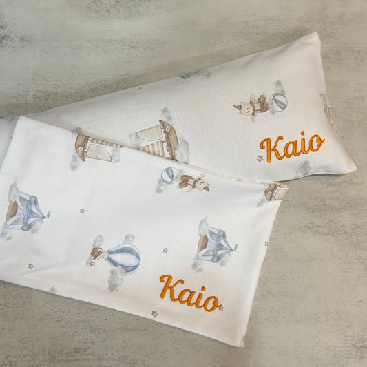 Two pillowcases with sailboat pattern and 'Kaio' branding on a textured surface
