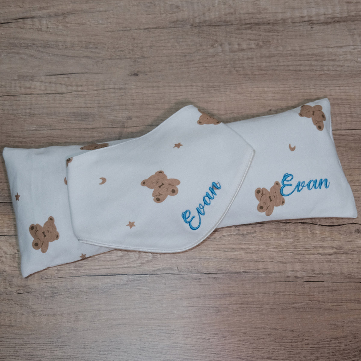 Teddy bear print husk pillow and bib embroidered with Evan in blue